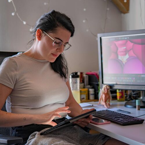 Beate Hoeller working on her computer and tablet