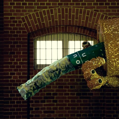 The cigarette monster is dragging on a cigarette.